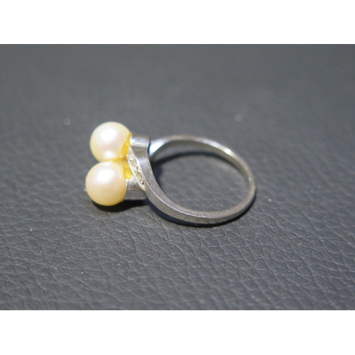 80 - A 14ct white gold pearl and diamond cross over ring size P/Q - weight approx 5.2 grams