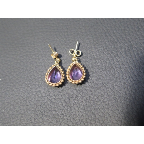 84 - A pair of 9ct yellow gold and amethyst drop earrings - approx 1.8cm - weight approx 2.7 grams