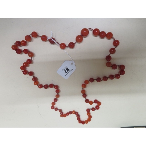 87 - A cabochon carnelian graduated bead necklace on silk string - approx 54cm