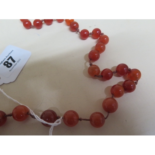 87 - A cabochon carnelian graduated bead necklace on silk string - approx 54cm