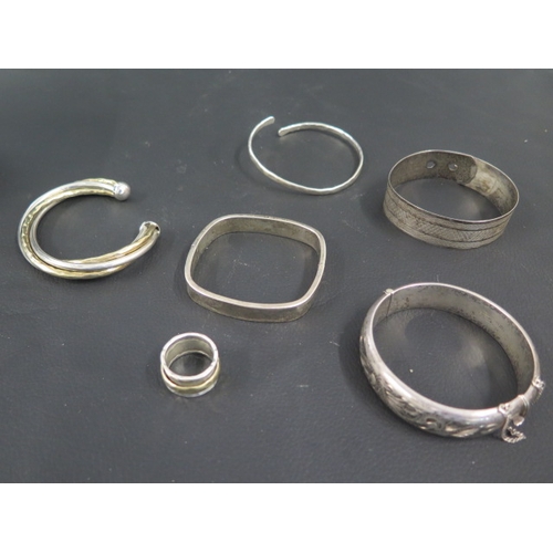 99 - Five silver bangles/bracelets and a silver ring - total weight approx 122 grams