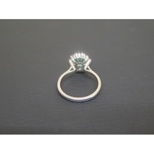 173 - A good emerald and diamond cluster ring - The oval central stone approx 1.5ct and surrounded by 12 b... 