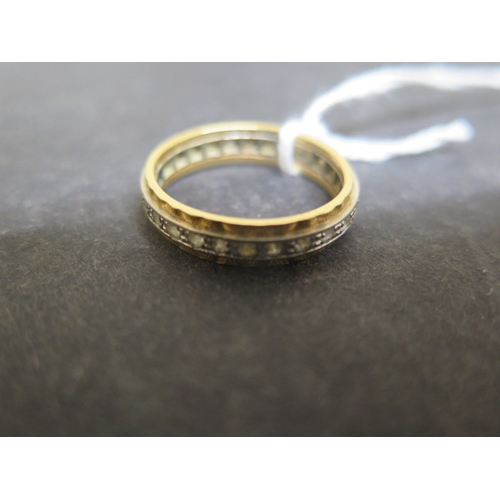 214 - An 18ct bi colour gold and CZ eternity ring size O - weight approx 4.4 grams