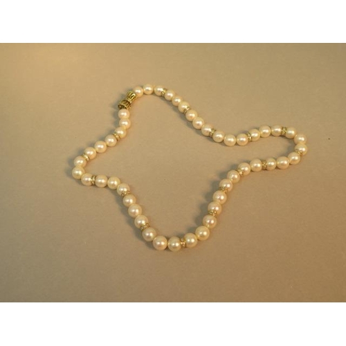 103 - A single string of pearls with 14ct (hallmarked) yellow gold clasp with diamonds, pearls divided wit... 