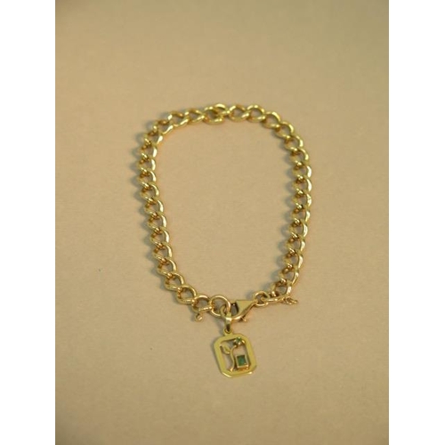 104 - A 9ct yellow gold bracelet (hallmarked) with 18ct (tested) charm/pendant set with emeralds - approx ... 