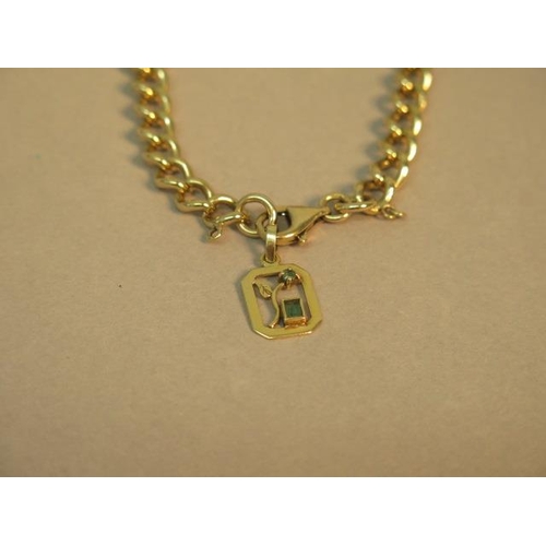 104 - A 9ct yellow gold bracelet (hallmarked) with 18ct (tested) charm/pendant set with emeralds - approx ... 