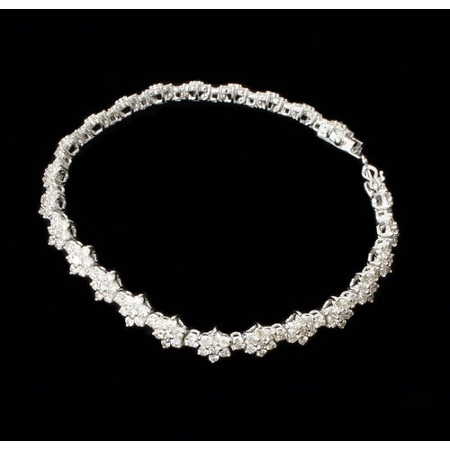 106 - An 18ct white gold daisy-style diamond cluster bracelet, with double safety clasp and box - round br... 