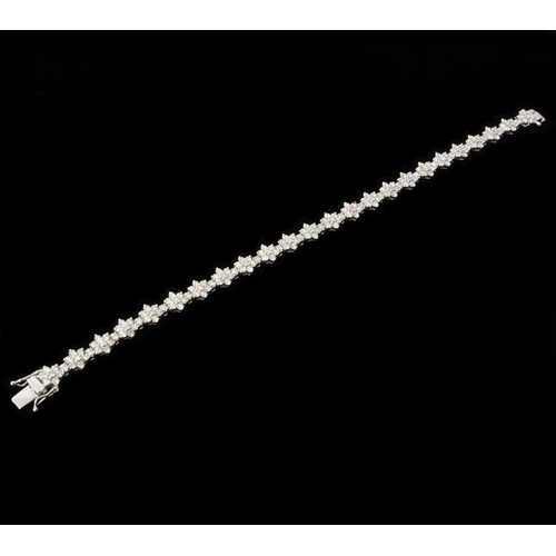 106 - An 18ct white gold daisy-style diamond cluster bracelet, with double safety clasp and box - round br... 