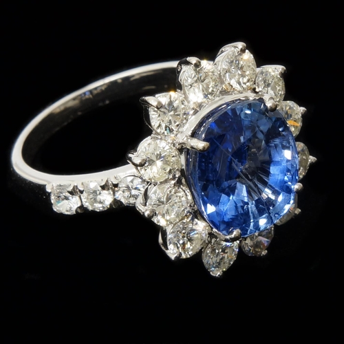 110 - A certificated 18ct white gold round cushion cut sapphire and round brilliant cut diamond cluster ri... 