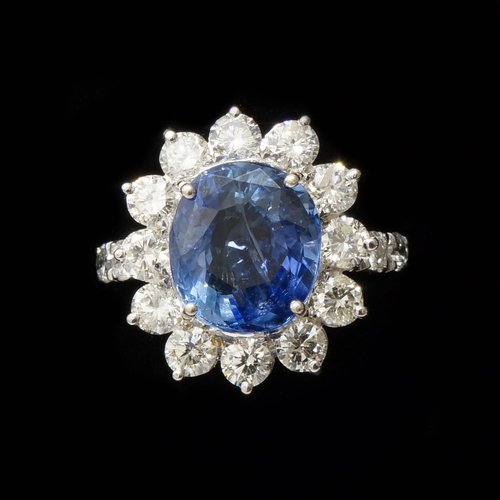 110 - A certificated 18ct white gold round cushion cut sapphire and round brilliant cut diamond cluster ri... 