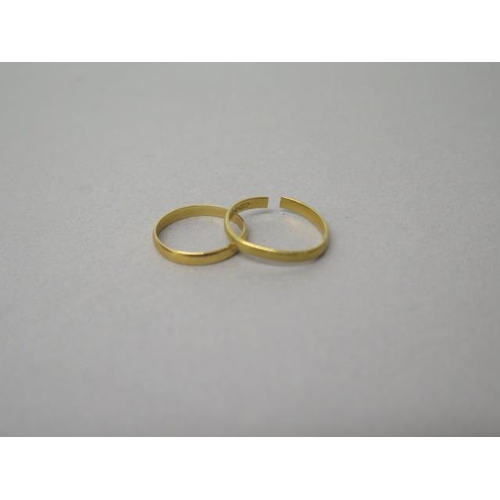 115 - Two 22ct yellow gold (hallmarked) bands - one split, other size L - total weight approx 3.5 grams