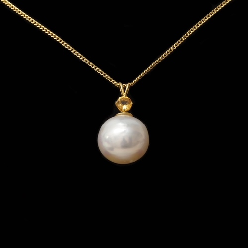 117 - A large 9ct yellow gold cultured pearl and citrine pendant on a gold-plated silver chain