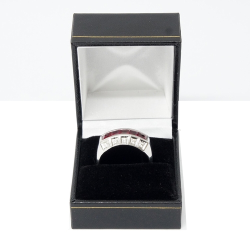 126 - A handmade 18ct white gold Art Deco style ring (10.1g) channel set with princess cut rubies, with ro... 