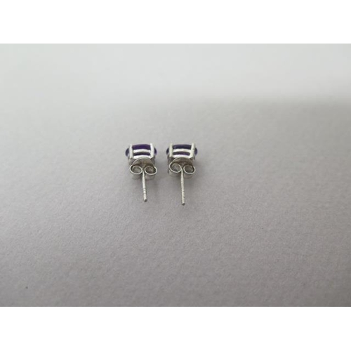 128 - A pair of amethyst studs in silver