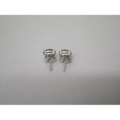 133 - A pair of alexandrite studs in silver