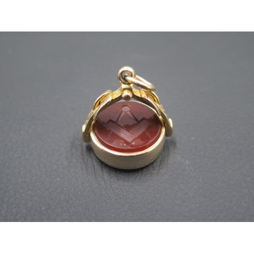 142 - A good Masonic 9ct (hallmarked) yellow gold swivel fob, set with bloodstone and carved carnelian wit... 