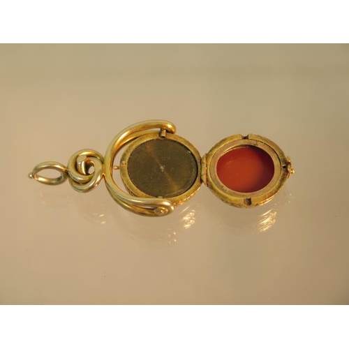 143 - An unusual 9ct (tested) yellow gold swivel fob set with compass (working) finely chased case hinged ... 