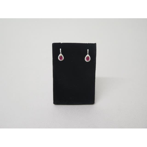 163 - A pair of ruby and diamond cluster drop earrings in 18ct white gold (hallmarked) - approx 1.8cm - we... 