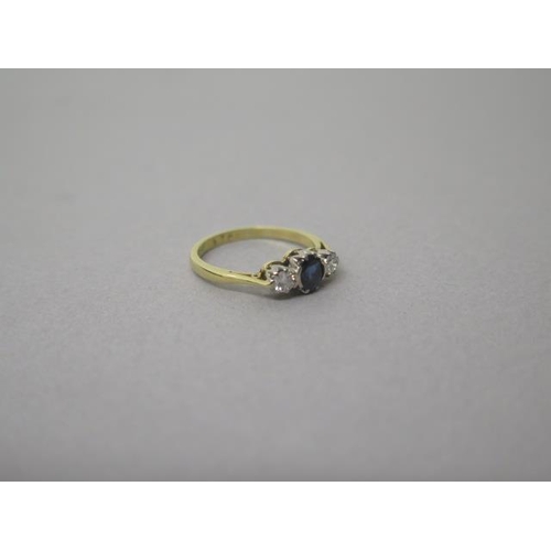 165 - An 18ct yellow gold (hallmarked) three stone sapphire and diamond ring size K/L - weight approx 2.5 ... 