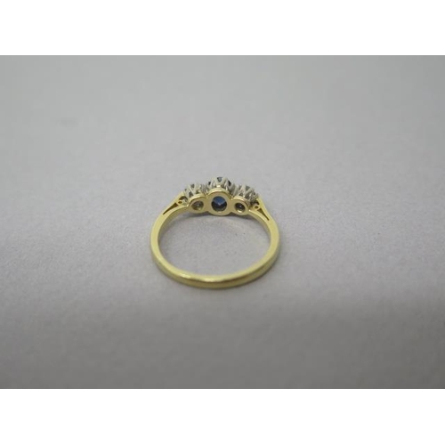 165 - An 18ct yellow gold (hallmarked) three stone sapphire and diamond ring size K/L - weight approx 2.5 ... 