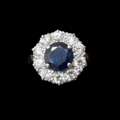 169 - A good sapphire and diamond cluster ring - central sapphire approx 7mm diameter surrounded by 10 rou... 