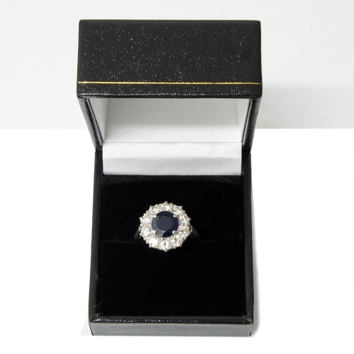 169 - A good sapphire and diamond cluster ring - central sapphire approx 7mm diameter surrounded by 10 rou... 