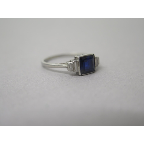 182 - A platinum (hallmarked) sapphire and diamond ring - the central square sapphire approx 6mm with bagu... 