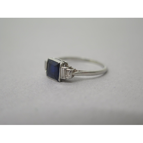 182 - A platinum (hallmarked) sapphire and diamond ring - the central square sapphire approx 6mm with bagu... 