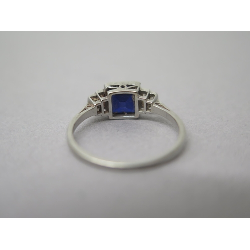 182 - A platinum (hallmarked) sapphire and diamond ring - the central square sapphire approx 6mm with bagu... 