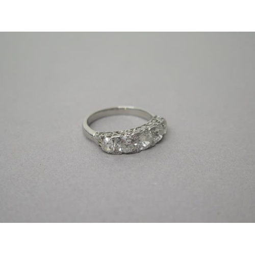 1A - A very good early 20th century diamond five stone ring set in carved platinum shank - five old mine ... 