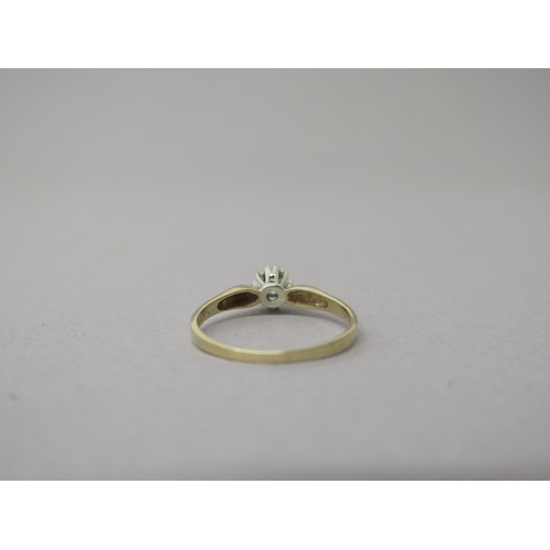 205 - A 9ct yellow gold solitaire diamond ring - head size approx 7mm diameter - ring size T