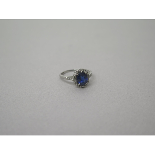 207 - An Art Deco sapphire and diamond ring set in platinum (hallmarked)  the central oval sapphire surrou... 