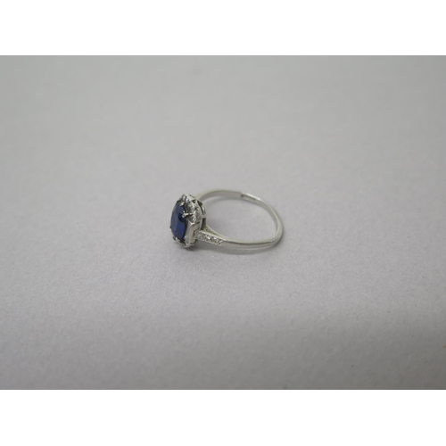 207 - An Art Deco sapphire and diamond ring set in platinum (hallmarked)  the central oval sapphire surrou... 