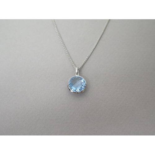 211 - A blue topaz and diamond pendant on chain set in 18ct white gold (hallmarked) chequer board cut roun... 