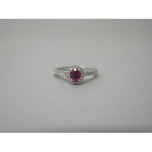 218 - A platinum ruby and diamond ring - diamonds well matched, bright and lively - head size approx 8mm x... 