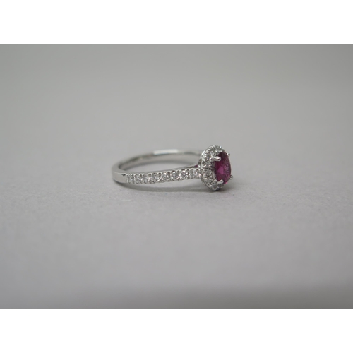 218 - A platinum ruby and diamond ring - diamonds well matched, bright and lively - head size approx 8mm x... 