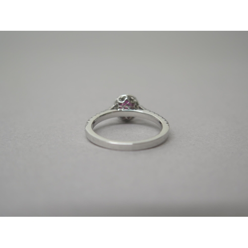 218 - A platinum ruby and diamond ring - diamonds well matched, bright and lively - head size approx 8mm x... 