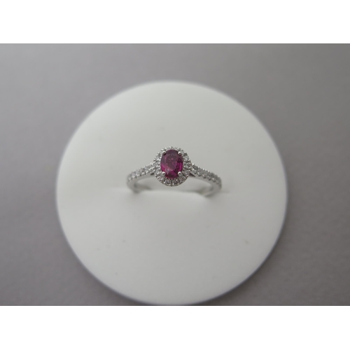 218 - A platinum ruby and diamond ring - diamonds well matched, bright and lively - head size approx 8mm x... 