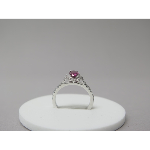 218 - A platinum ruby and diamond ring - diamonds well matched, bright and lively - head size approx 8mm x... 