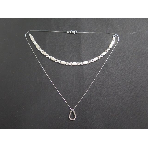 23 - A 9ct white gold pendant on chain, tear drop shaped pendant approx 1.5cm - set with diamond accent, ... 