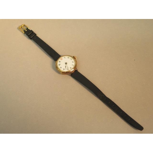 244 - A 15ct yellow gold (hallmarked) cased ladies Trench watch - round case approx 23mm with leather stra... 