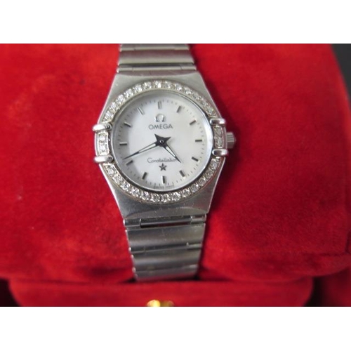 273 - An Omega ladies Constellation wristwatch with diamonds set around the bezel - with box and papers an... 