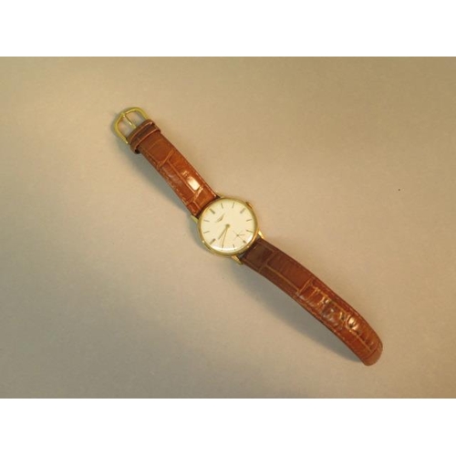 274 - A gents 18ct gold Longines watch with seconds hand on a leather strap - in its original Watches of S... 