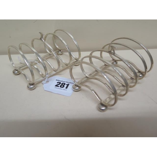 281 - A pair of silver four slice toast racks, Birmingham 1920, kidney shaped on bun feet - approx 9cm x 7... 