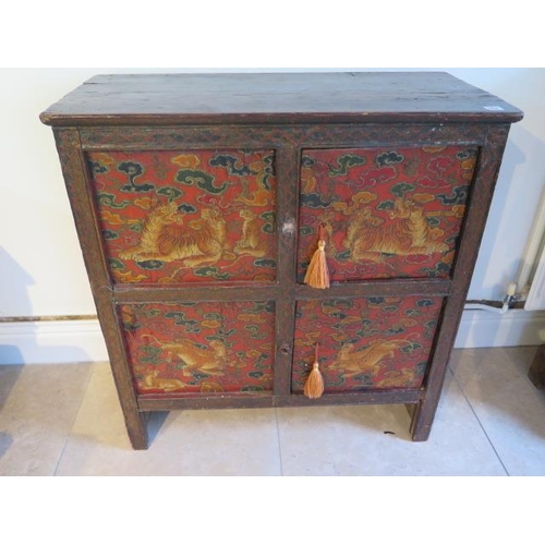 502 - A Tibetan hand painted panelled cabinet decorated with tigers and leopards with two small doors for ... 