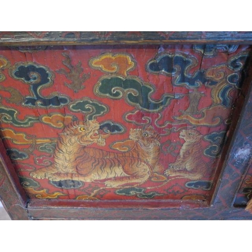 502 - A Tibetan hand painted panelled cabinet decorated with tigers and leopards with two small doors for ... 