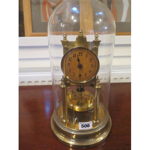 506 - A brass Anniversary clock under a glass dome