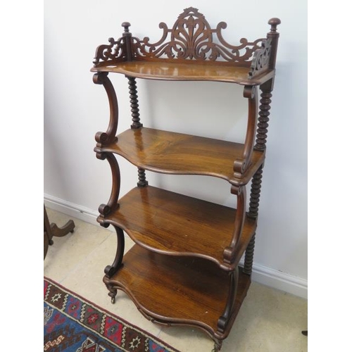 507 - A 19th century rosewood four tier whatnot with a fretwork top and scroll supports - in good conditio... 