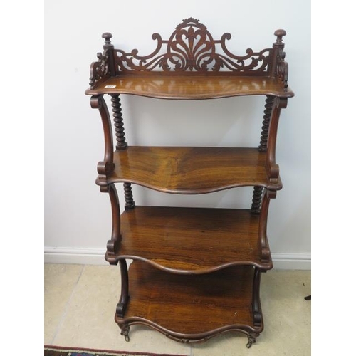 507 - A 19th century rosewood four tier whatnot with a fretwork top and scroll supports - in good conditio... 