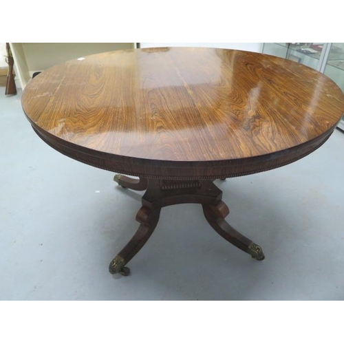 509 - A Regency period rosewood circular tilt top dining table - Diameter 115cm - on four out swept legs w... 